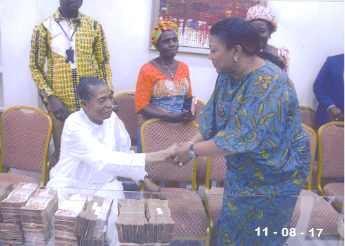 First Lady Rebecca Naa Okaikor Akufo-Addo receiving the donation from Apostle Dr Ing. Kwadwo Safo