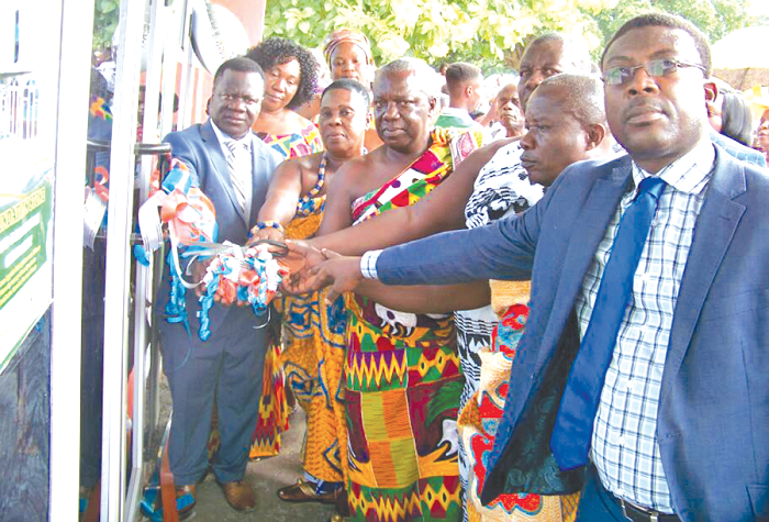 Nana Agyeiwaa Kodie II Queen mother of the town assisted by Nana Oduro Yeboah iii, Yonso chief of Ashanti and other chiefs and elders of the SDA Church to cut the tape to Inaugurates the building