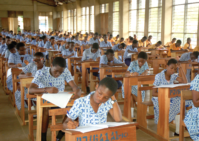  Some JHS students writing the BECE