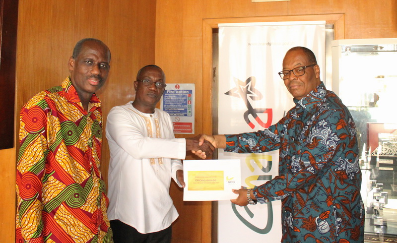 Mr. Anselm Ray Sowah, (right) Managing Director of GCB Bank handing over the cheque 