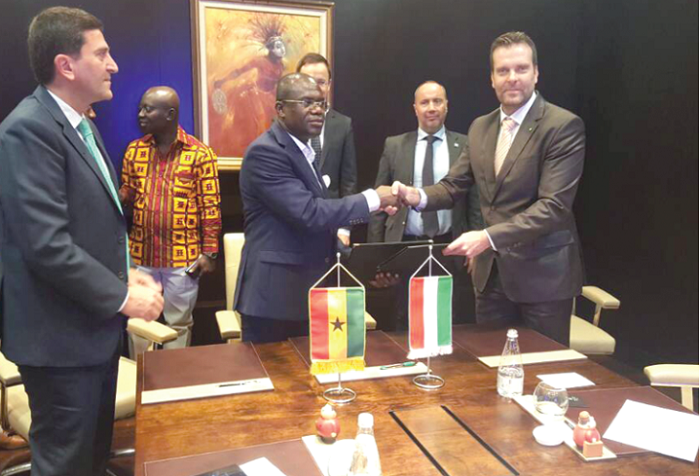 Mr Agyapong exchanging the agreement with Mr Horvath, CEO of Pureco,while other officials look on