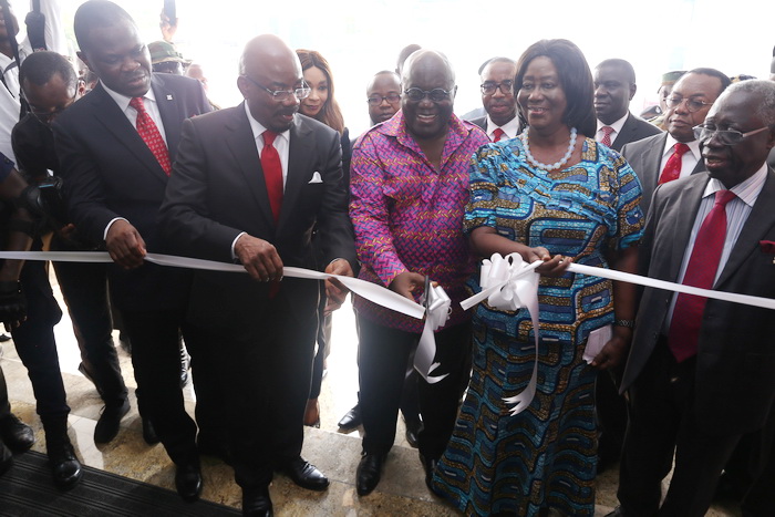 President Akufo-Addo being supported by Dr (Mrs) Mary Chinery-Hesse (2nd right), the Board Chair, Zenith Bank, and Mr Jim Ovia (CON), Group Chairman, Zenith Bank, to cut the tape to inaugurate the building
