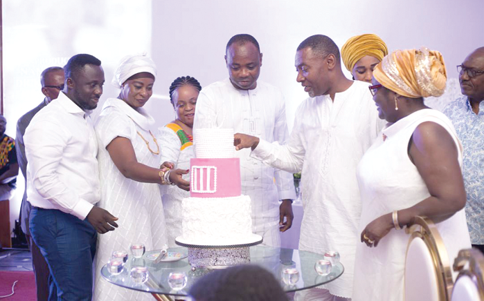 Mr Appiah (middle) cutting his 40th birthday cake with some friends and family.