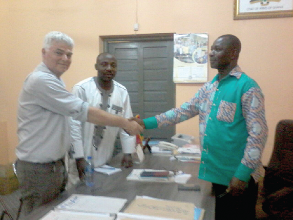  Mr Lawrence Kwami Aziale (right), the  Jasikan DCE, welcoming Mr Greg Marsh (left), the founder and programmes manager of BYKA Group, to his office