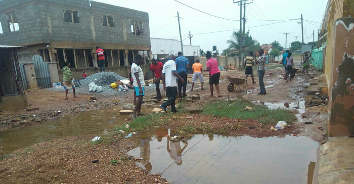 Some residents clearing garbage from their homes