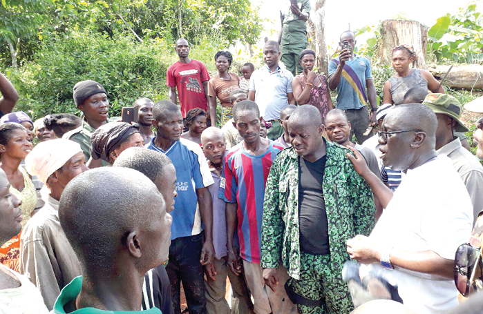 Mr Owusu-Afriyie (right) addressing some of the farmers at Sefwi Wiawso