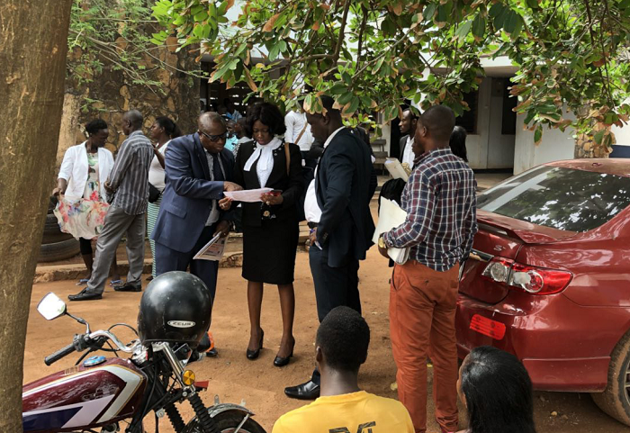 Mrs Evelyn Keelson (middle), a principal state attorney, having a discussion with some of the investigators of the case.