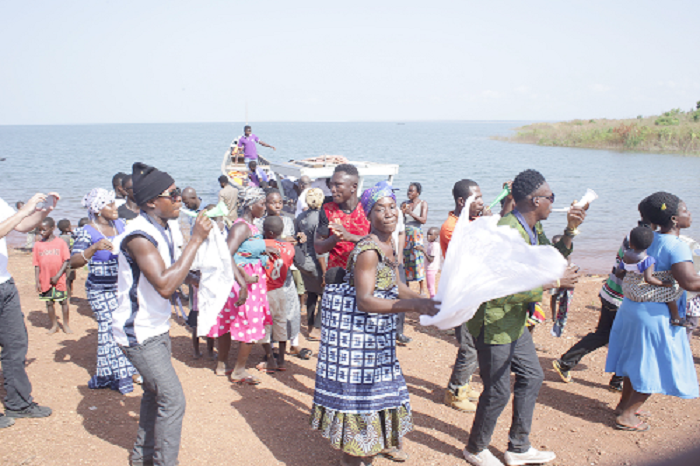  some islanders jubilating when a team of journalists and other officials arrived on the island