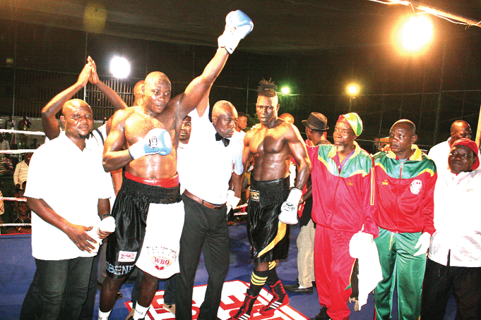  Referee Adore Bertin from Benin lifts the hand of winner, Ebenezer Tetteh