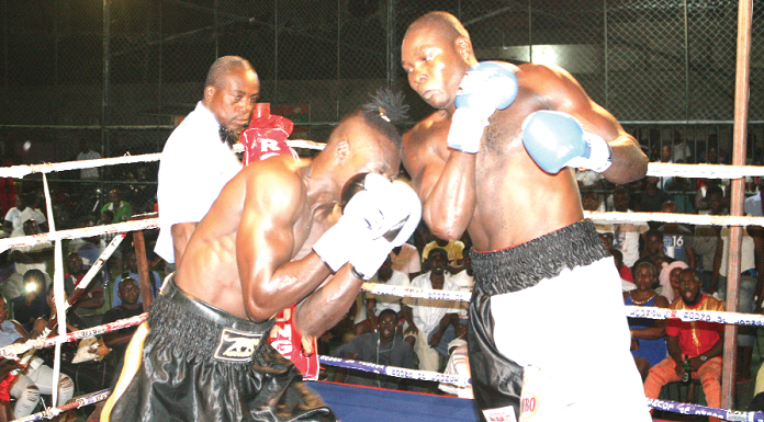  Tetteh connects a right hook to the guarded face of Kabore