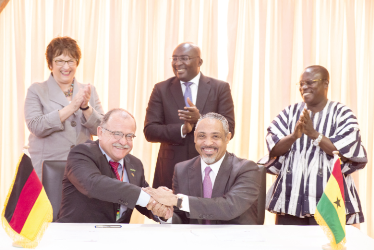  Dr Fritz Sacher of Merck and Andrew Clocanas of RMS, after signing the MoU. Vice President, Dr Mahamudu Bawumia (standing middle) and Germany’s Minister for Economy and Energy, Brigitte Zypries (standing left) and Deputy Health Minister, Mr Kingsley Aboagye-Gyedu, witnessed the signing of the MoU