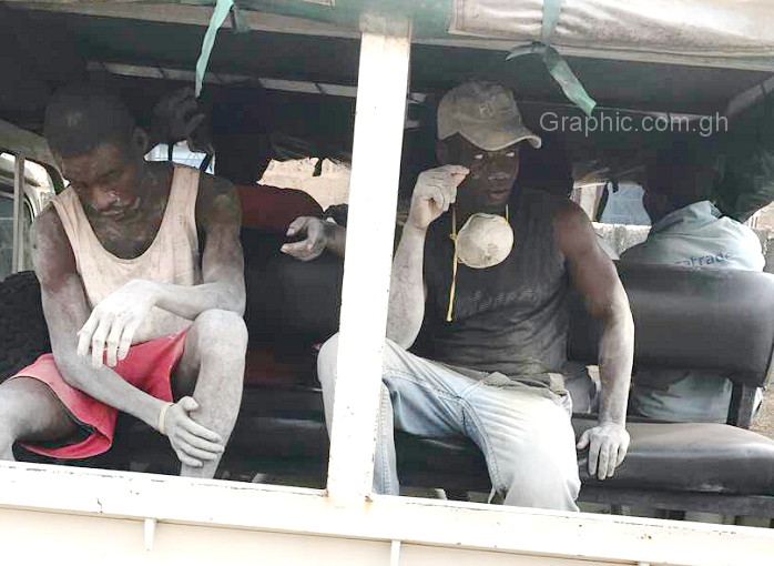 Some of the suspects being whisked away in a police vehicle
