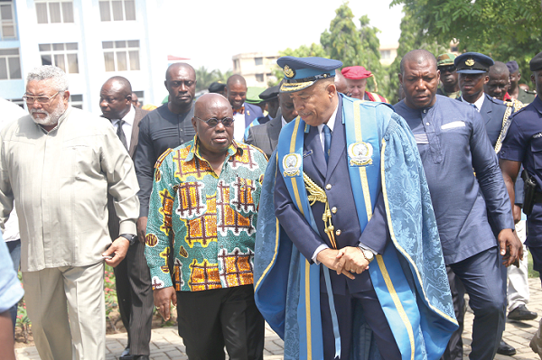 Air Vice Marshal Griffiths Santrofi Evans (right), Commandant, KAIPTC briefing President Akufo-Addo on some issues after the ceremony in Accra. Looking on is former President Jerry John Rawlings. Picture: SAMUEL TEI ADANO