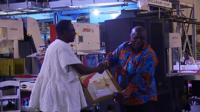Mr Mathias Asabrie receiving an award as the overall best worker for 2017