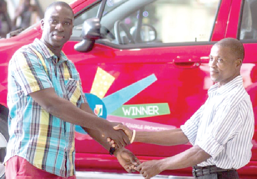Michael Konadu (left), Marketing Manager at West Hills Mall congratulating Francis Mensah after giving him the keys to the Chevrolet Sparkle Lite Saloon car