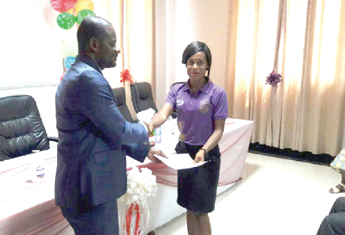 • Dr Kwofie (left) presenting a certificate  to one of the first aid givers