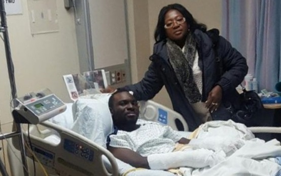Maggie Yeboah, volunteer coordinator for African Communities of Manitoba and president of the Ghanaian Union of Manitoba, shown with Seidu Mohammed in hospital. Mohammed, a 24-year-old refugee from Ghana, was found on Highway 75 after crossing the US-Canada border and walking in the cold for several hours. 