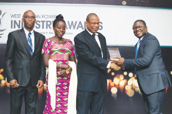 Mr Joseph Olayemi of Huawei, Nigeria, sponsors of the award, presenting the overall winner award to Mr Suraj Omoru Amadu of GRIDCo, while some officials of the company look on
