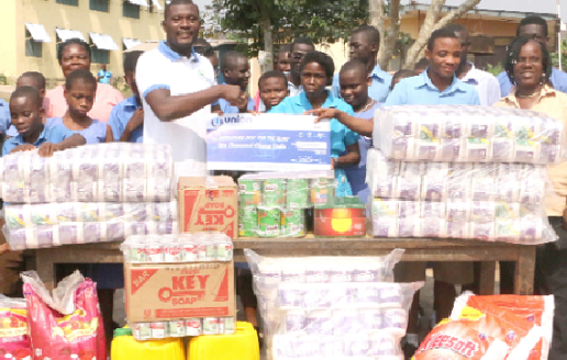 Zoomlion Foundation presenting some items and a cheque to the school