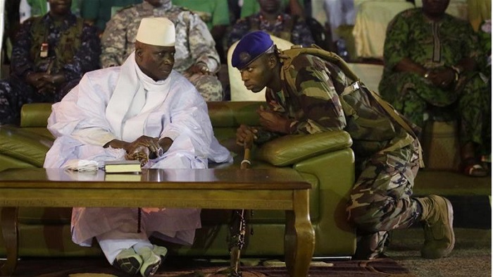 A Gambian officer speaks to President Jammeh in the capital Banjul in November 2016 [Jerome Delay/AP]