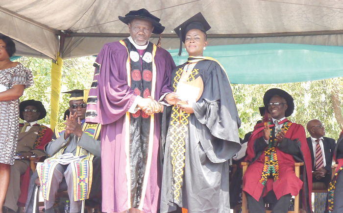  Most Rev. Titus K. Awotwi Pratt, Presiding Bishop of the Methodist Conference and Chairman of Council presenting the overall best student  award to  Ruby Akyere Bruce-Tagoe. PICTURE: PATRICK DICKSON