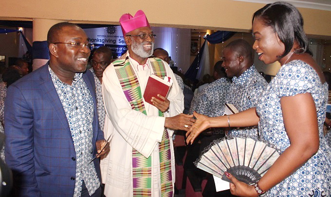 Arch Bishop Gabriel Palmer Buckle  (middle),  in a hearty interaction with an employee of the bank, Ms Maamle Ahegbebu (right), as the MD,  Mr Peter John Kweku Asamoah looks in admiration. Picture: NII MARTEY M. BOTCHWAY 