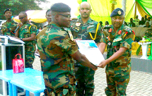 Brig Gen Cosmas Bietus Alhassan (right) presenting a citation to Corporal Nurudeen Yakubu (left) who was adjudged as the best soldier of the 3BN in 2016