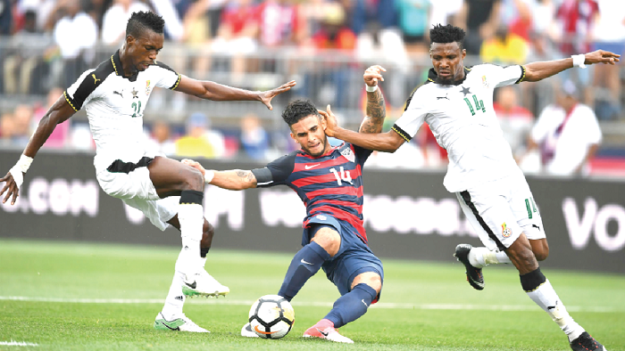 • USA’s Dom Dwyer is sandwiched by Ghana centre-backs John Boye (left) and Jeny Akaminko