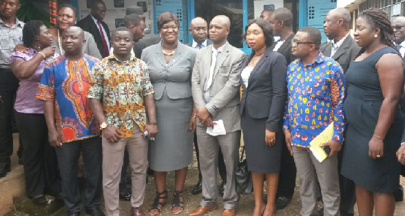 Officials of the insurance company and the university in a pose 