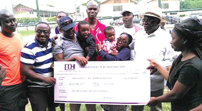 Ing Kirk Koffi (3rd left) and other members of the club presenting the dummy cheque to Mrs Barbara Mahama