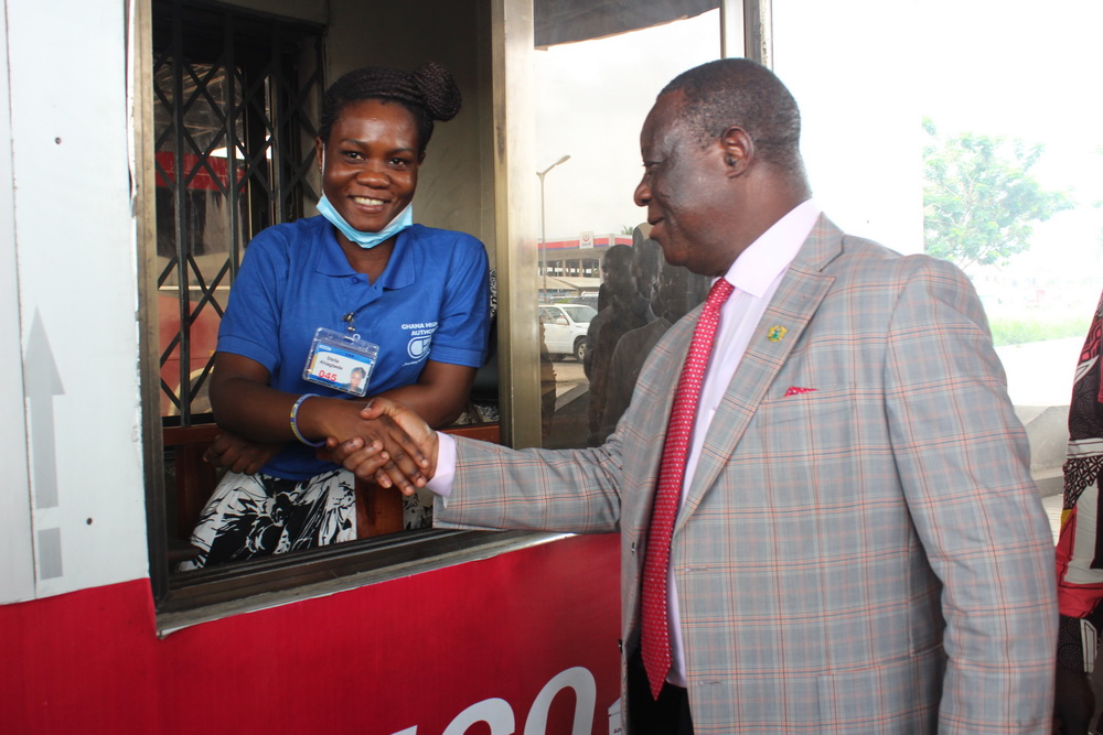 Flashback: Mr Kwasi Amoako-Atta (right), Minister of Roads and Highways congratulating Ms Stella Ahiadegbe, one of the PWDs, at a tollbooth