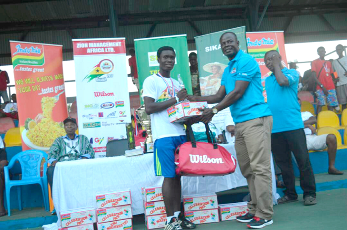 • Mr Joshua Mensah, presenting the items to Reginald Okantey, winner of the Under-16 category