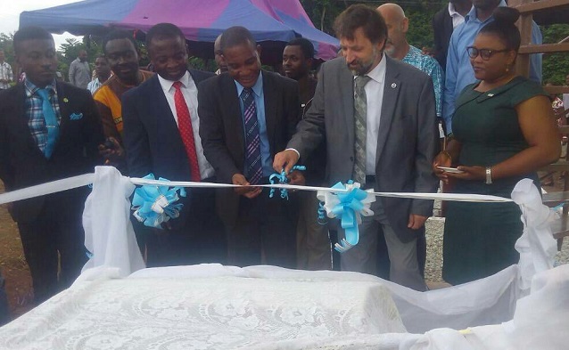 Prof Harrison Dapaah, Vice Chancellor of UENR (middle), being assisted by Mr Richard Ullman of the US National Oceanic and Atmospheric Administration  (NOAA) (2nd right) to inaugurate the facility