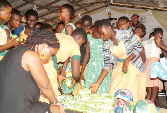 Some of the students inspecting the teaching and learning materials presented to the schools