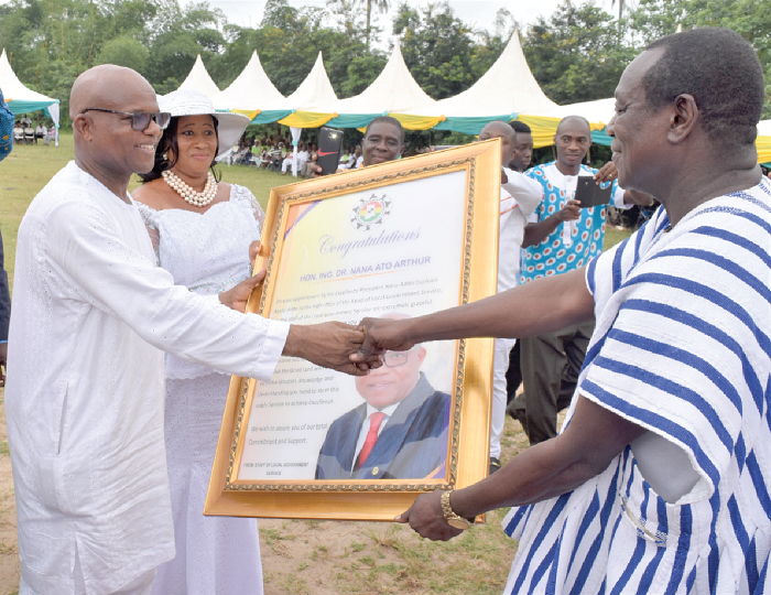 • Dr Ato Arthur (left) receiving a citation from Mr Joe Dasaanah, Chief Director at the  Local Government Service office