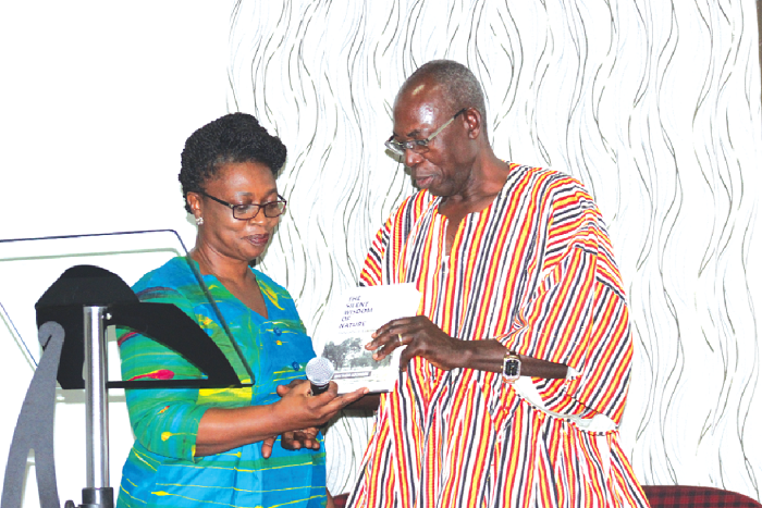 • (Mrs) Carlien Bou-Chedid, President for the Ghana Institution of Engineers, taking a good look at the book after launching it. Picture: BENEDICT OBUOBI