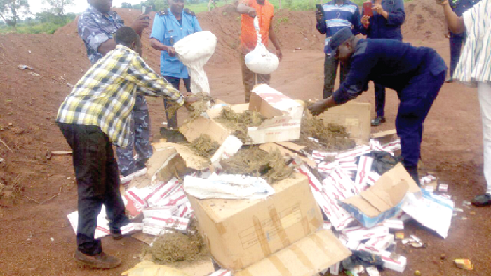• The cigarettes and the compressed Indian hemp before the destruction at the landfill site. 