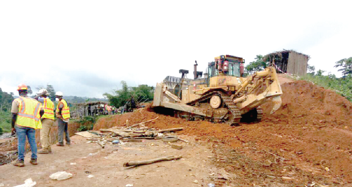 • An excavator­ covering a galamsey pit