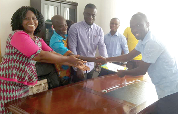 Mr Enoch Boateng (right), awarding some of the members of the 2017 class of Strategic Leadership at the University of Professional Studies, Accra