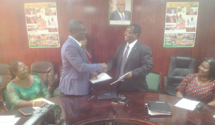 Prof Frimpong Boateng (left) in a handshake with Dr Abebe Haile after the signing