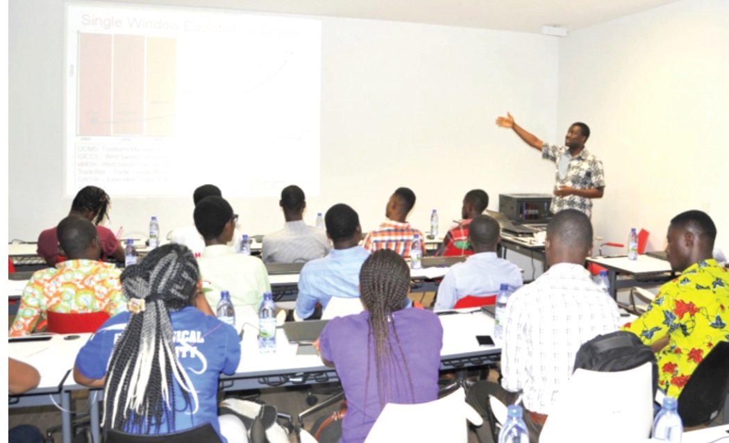 Mr Agyaaku Nkansah (hands raised) explaining the single window concept to the students 