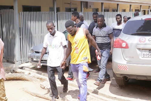 Some of the accused being escorted out of the courtroom
