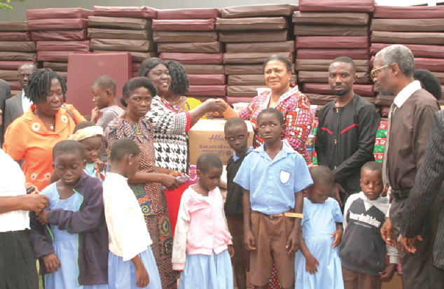 The first Lady presenting some of the items to the Akuapem North Municipal Director of Education, Ms Grace Owusua Addo