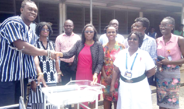 Dr Victoria May Adabayeri receiving the items from Mr Ezekiel Ansah (left)