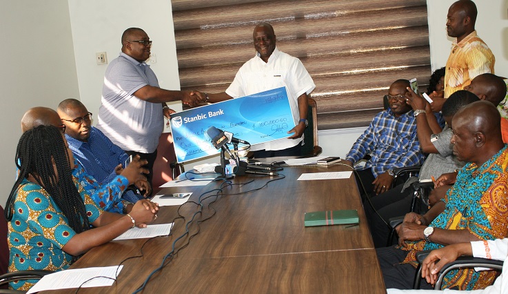 Mr John Prempeh (left), the Head of Transactional Products and Service, presenting a Cheque to Dr Felix Anyah (right), C.E.O of Korle-Bu Teaching Hospital