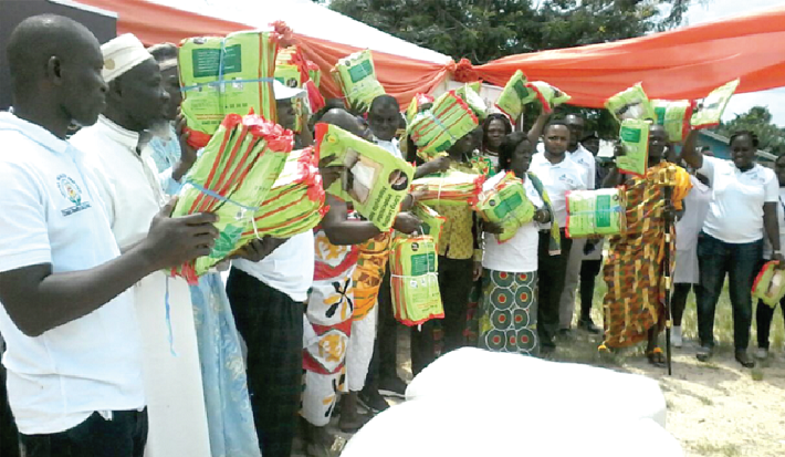 Some members of beneficiary communities displaying their insecticide treated nets