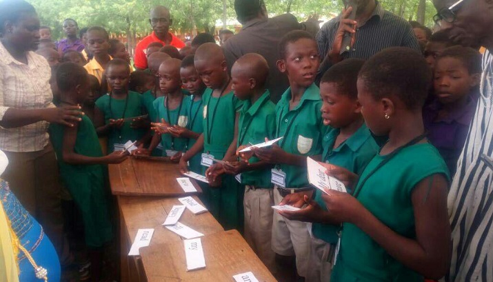 Some pupils trying to read what they have picked up