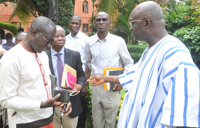 Mr Kofi Adda (right) interacting with some participants after the opening ceremony