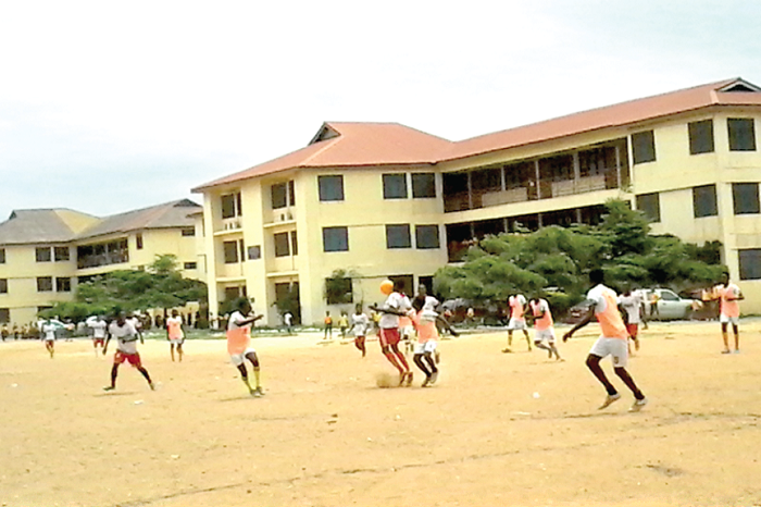 Players of Ablekuma North (in all white) and Osu Klottey battling it out in a midfield action during their football clash.