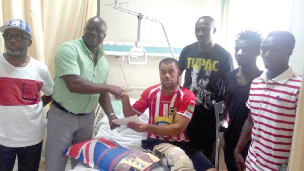 Coach Polack (on bed) receiving the cheques from the former Kotoko board member